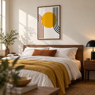 Bauhaus Sun Print, framed on the wall of a warm modern bedroom with a soft white wall