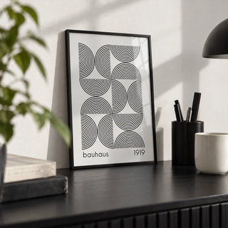 Bauhaus Wall Art, a small A4 framed print leaning on a black desk