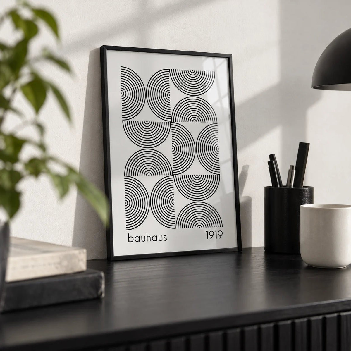 Bauhaus Wall Art, a small A4 framed print leaning on a black desk