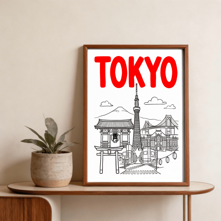 Framed Tokyo City wall art with red lettering and black line-art landmarks on a wooden table with a plant