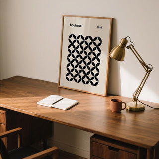 Minimalist mid century wall print with repeating circle-based forms in black and tan tones.