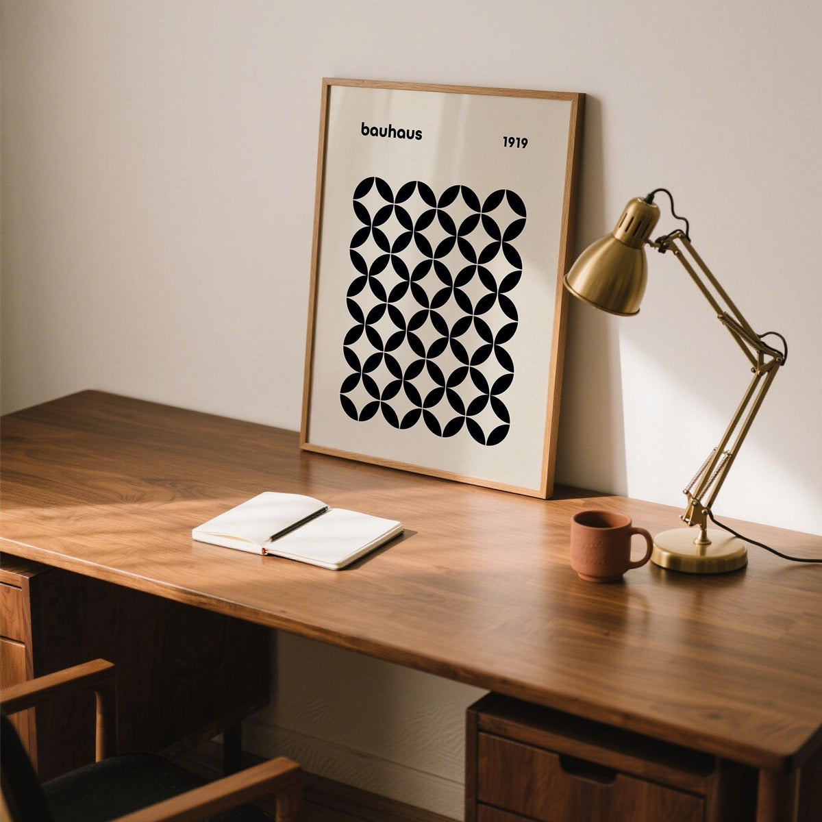 Minimalist mid century wall print with repeating circle-based forms in black and tan tones.