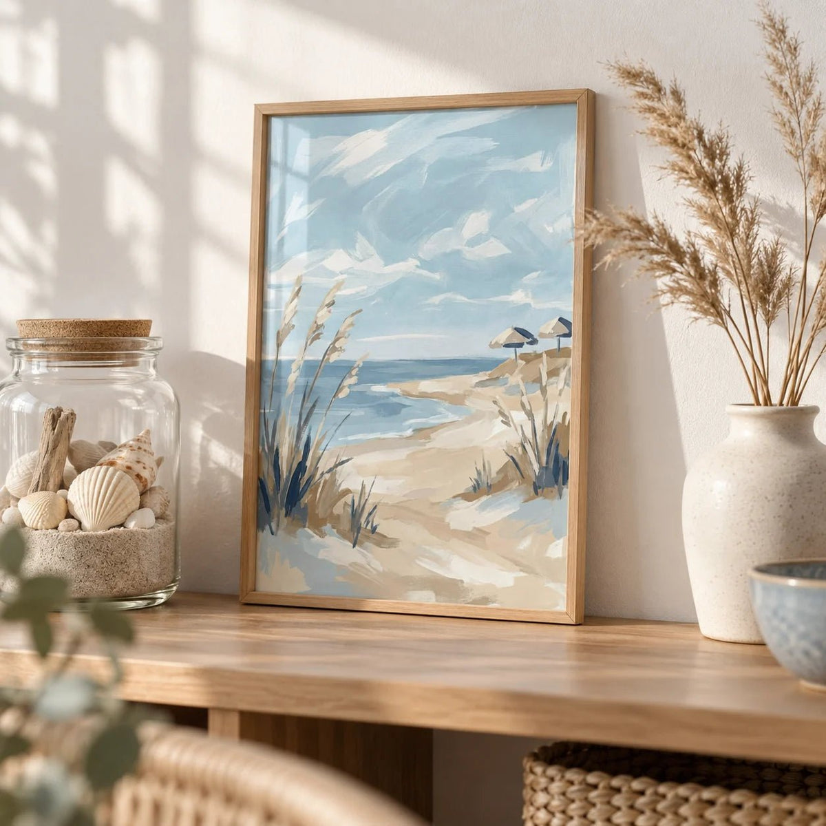 Beach Landscape Art Print, a small A4 framed print leaning on an oak shelf in a living room