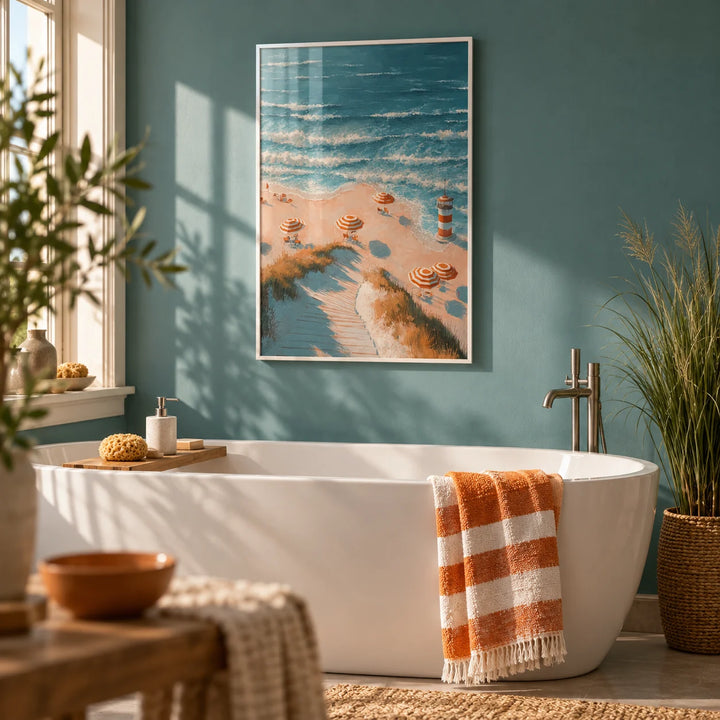 Beach Lighthouse Print, framed on the wall of a calm bathroom with a teal painted wall and a white bath