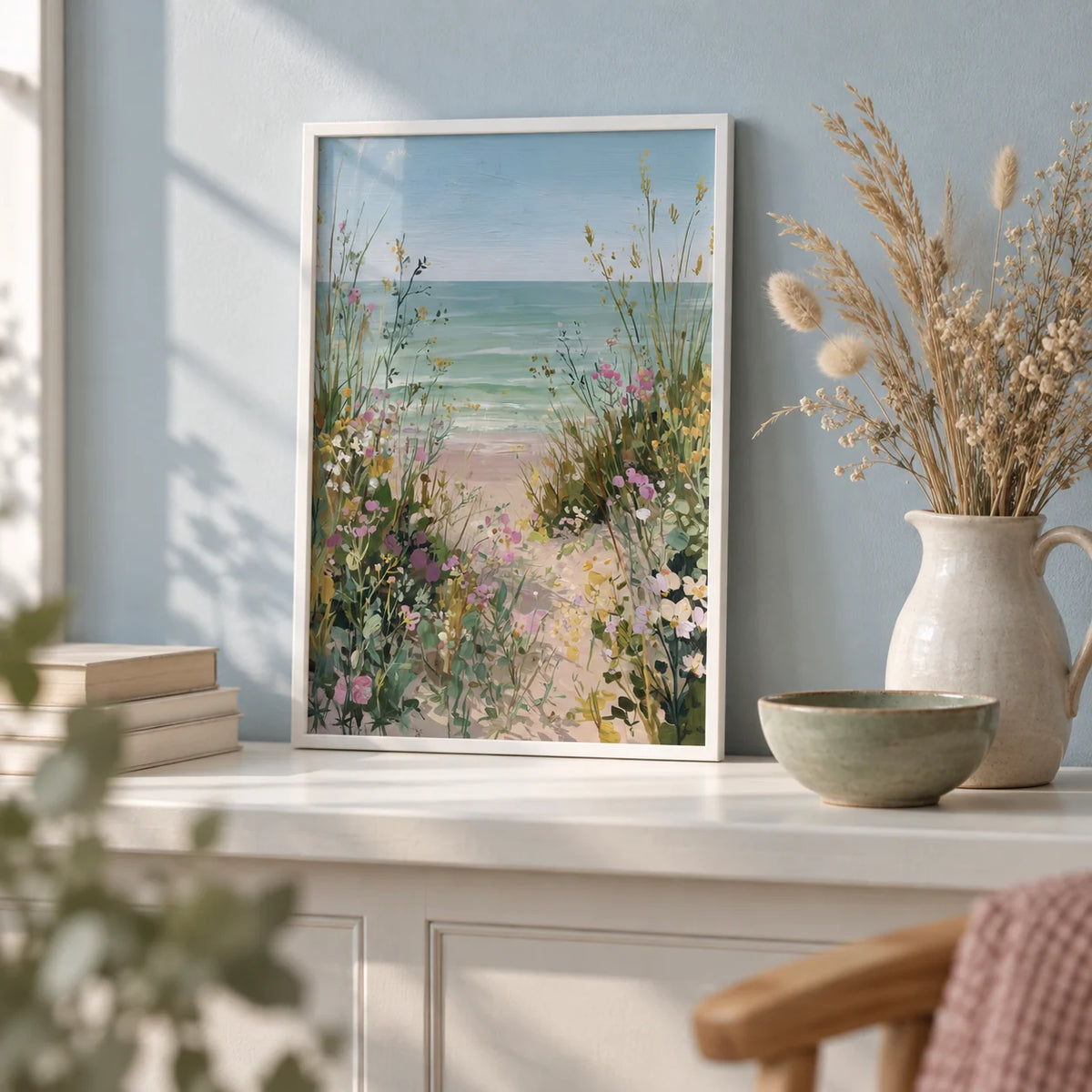 Beach Path Print, a small A4 framed print leaning on a white painted shelf in a living room