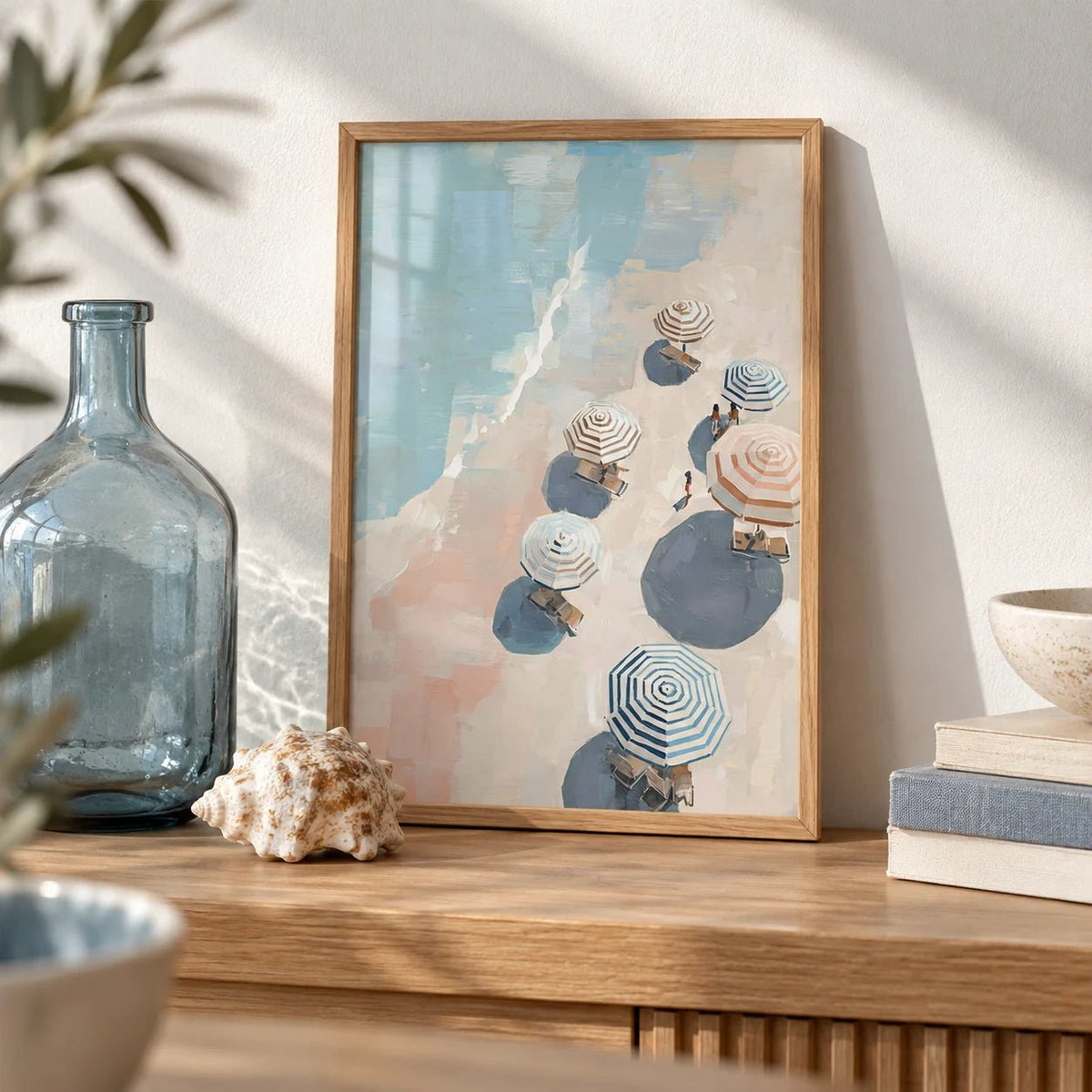 Beach Umbrella Print, a small A4 framed print leaning on an oak shelf in a living room