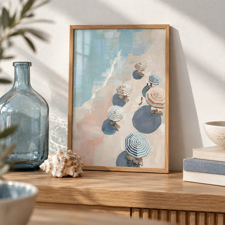 Beach Umbrella Print, a small A4 framed print leaning on an oak shelf in a living room