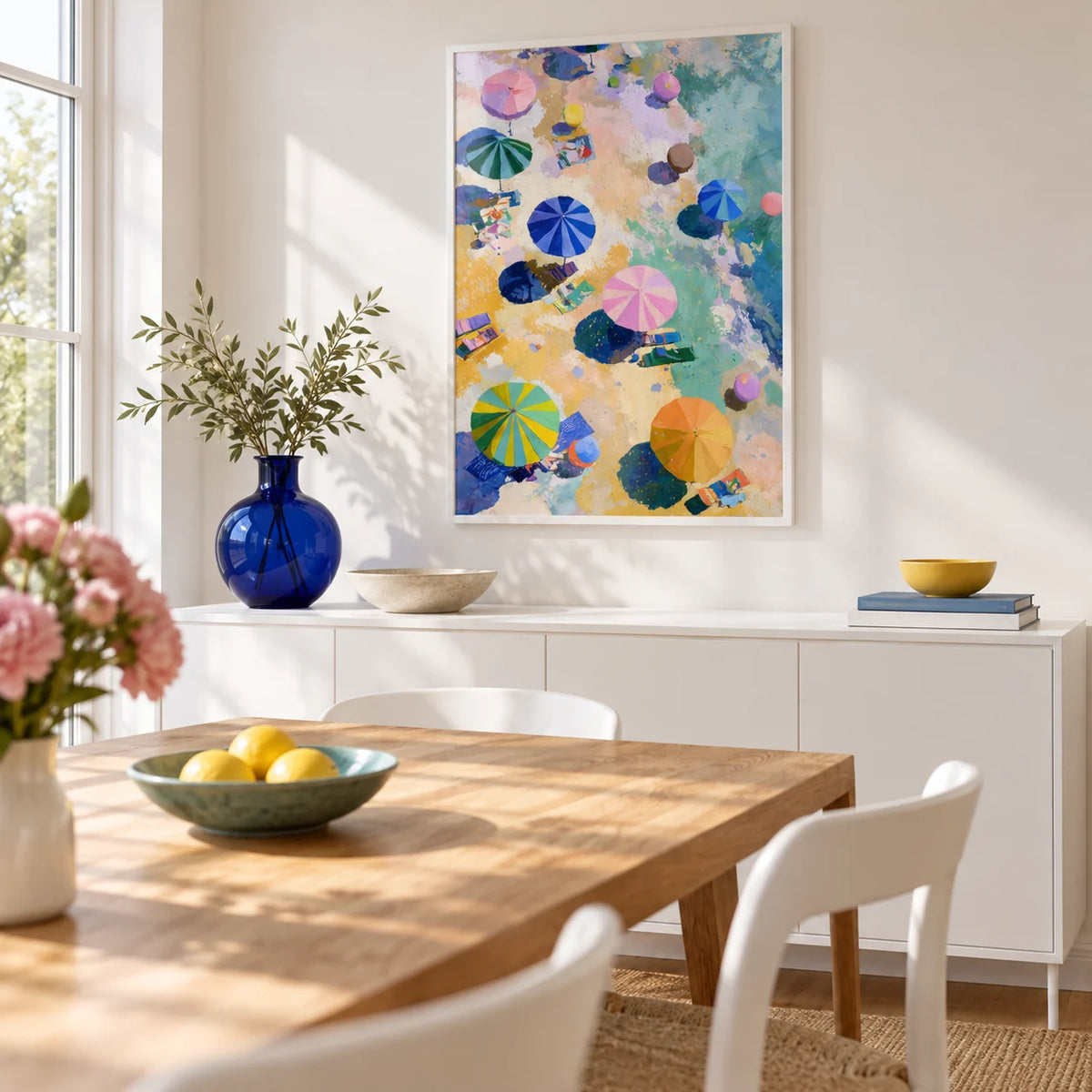 Beach Umbrellas Print, framed on the wall of a bright dining room with a white wall