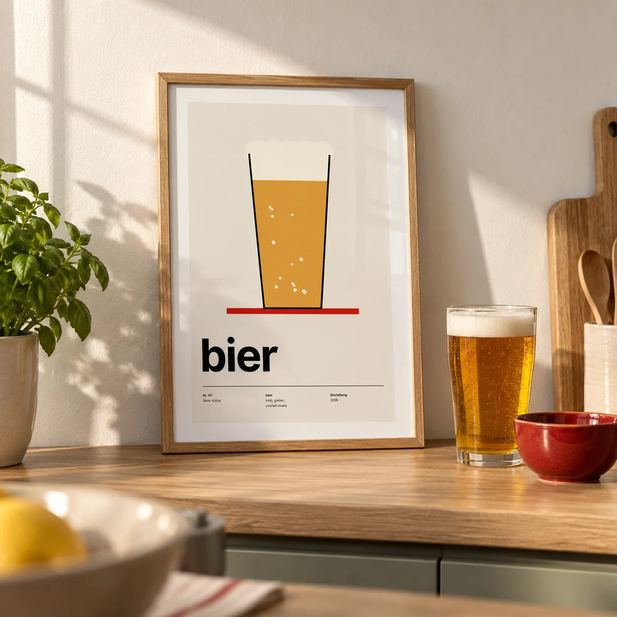 Beer Poster, a small A4 framed print leaning on a pale oak kitchen worktop