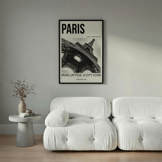 Black and white iron lattice photograph of the Eiffel Tower arch beams