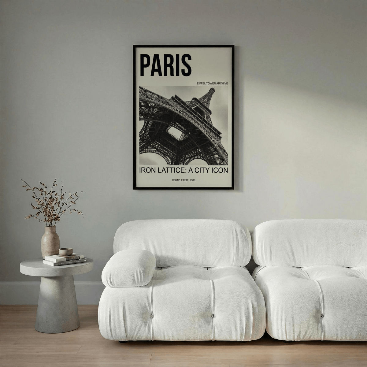 Black and white iron lattice photograph of the Eiffel Tower arch beams