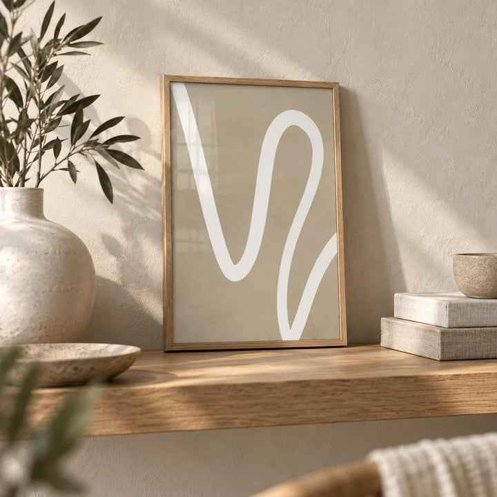 Beige Wall Art, a small A4 framed print leaning on an oak shelf in a living room