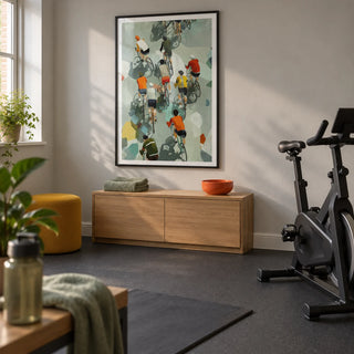 Bicycle Riders Wall Art, framed on the wall of a compact home exercise room in a UK house with pale grey walls and a plain charcoal rubber floor