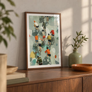 Bicycle Riders Wall Art, a small A4 framed print leaning on a walnut sideboard in a living room