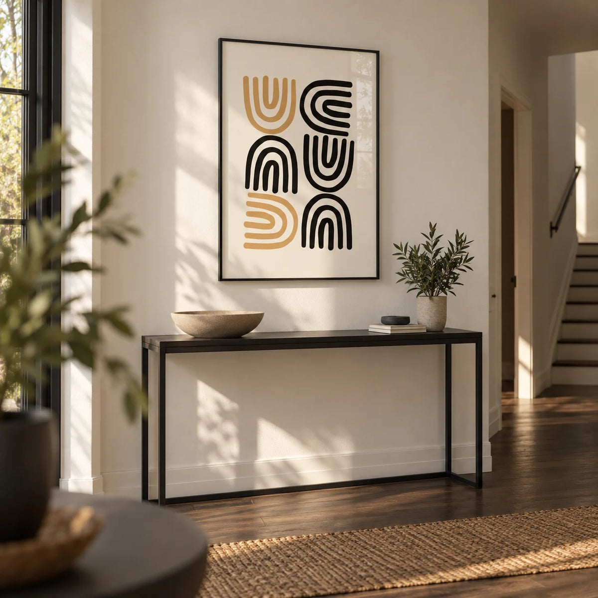 Black and Gold Pictures, framed on the wall of a calm hallway with an off-white wall and a dark wood floor
