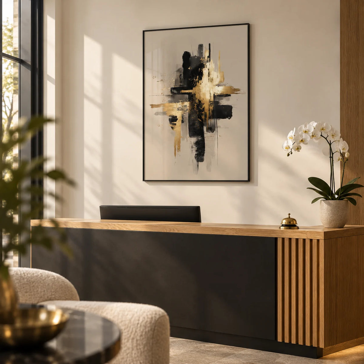Black And Gold Poster, framed on the wall of a small boutique office reception with a warm white wall