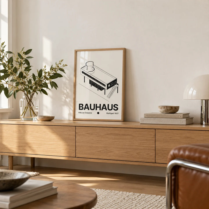 Black and White Architecture Poster, a small A4 framed print leaning on a low pale wooden side table in a hallway