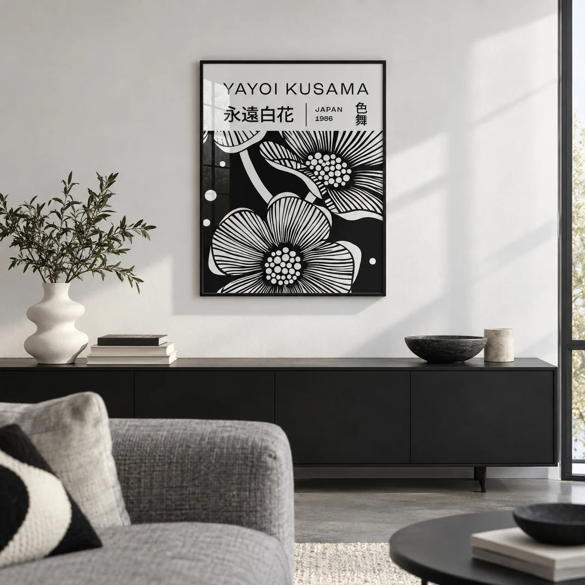 Black and White Art Flowers, framed on the wall of a crisp design-led city flat living room with a white wall and a polished concrete floor