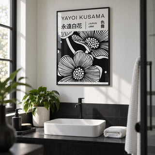 Black and White Art Flowers, framed on the wall of a modern monochrome bathroom with a white wall and plain black tiles below
