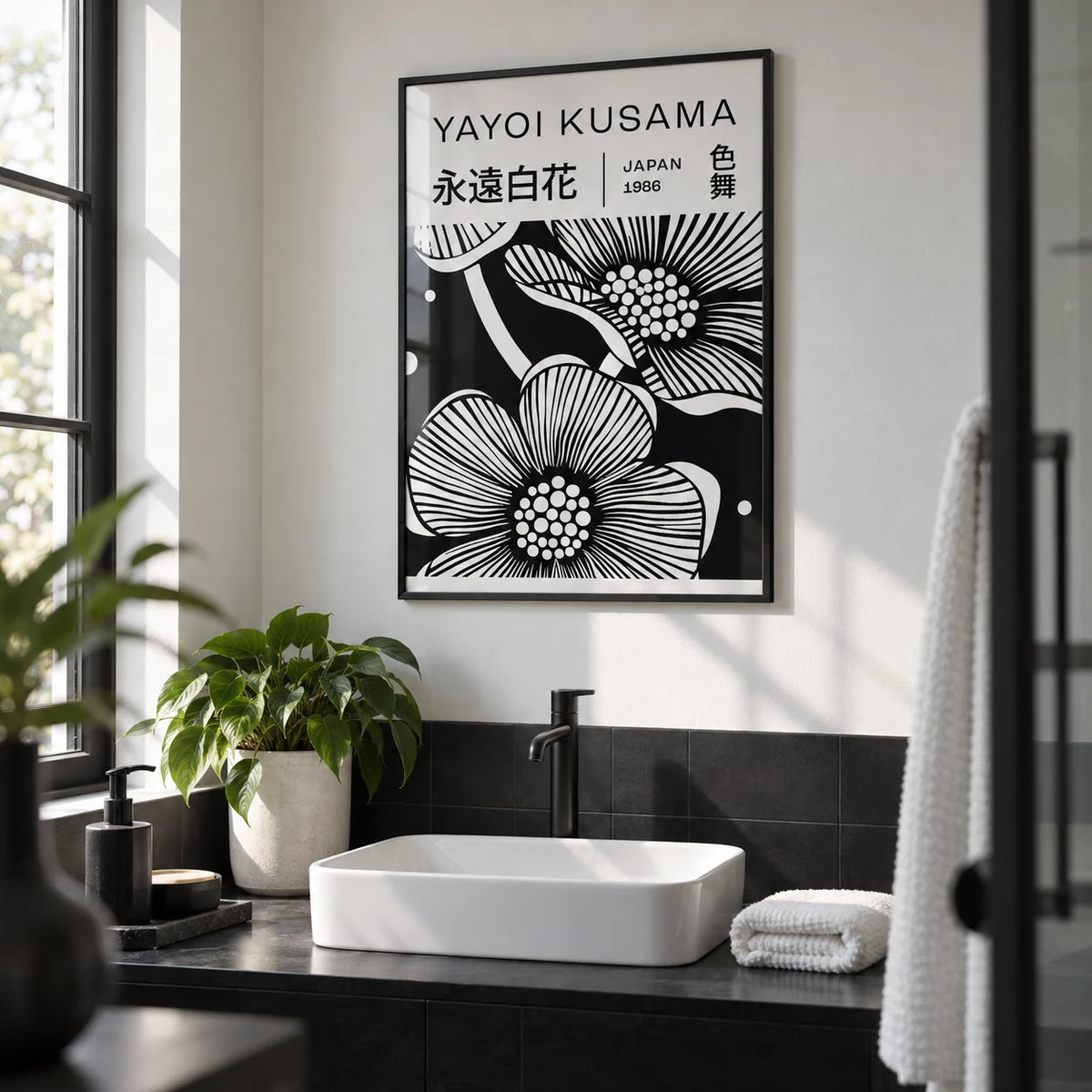 Black and White Art Flowers, framed on the wall of a modern monochrome bathroom with a white wall and plain black tiles below