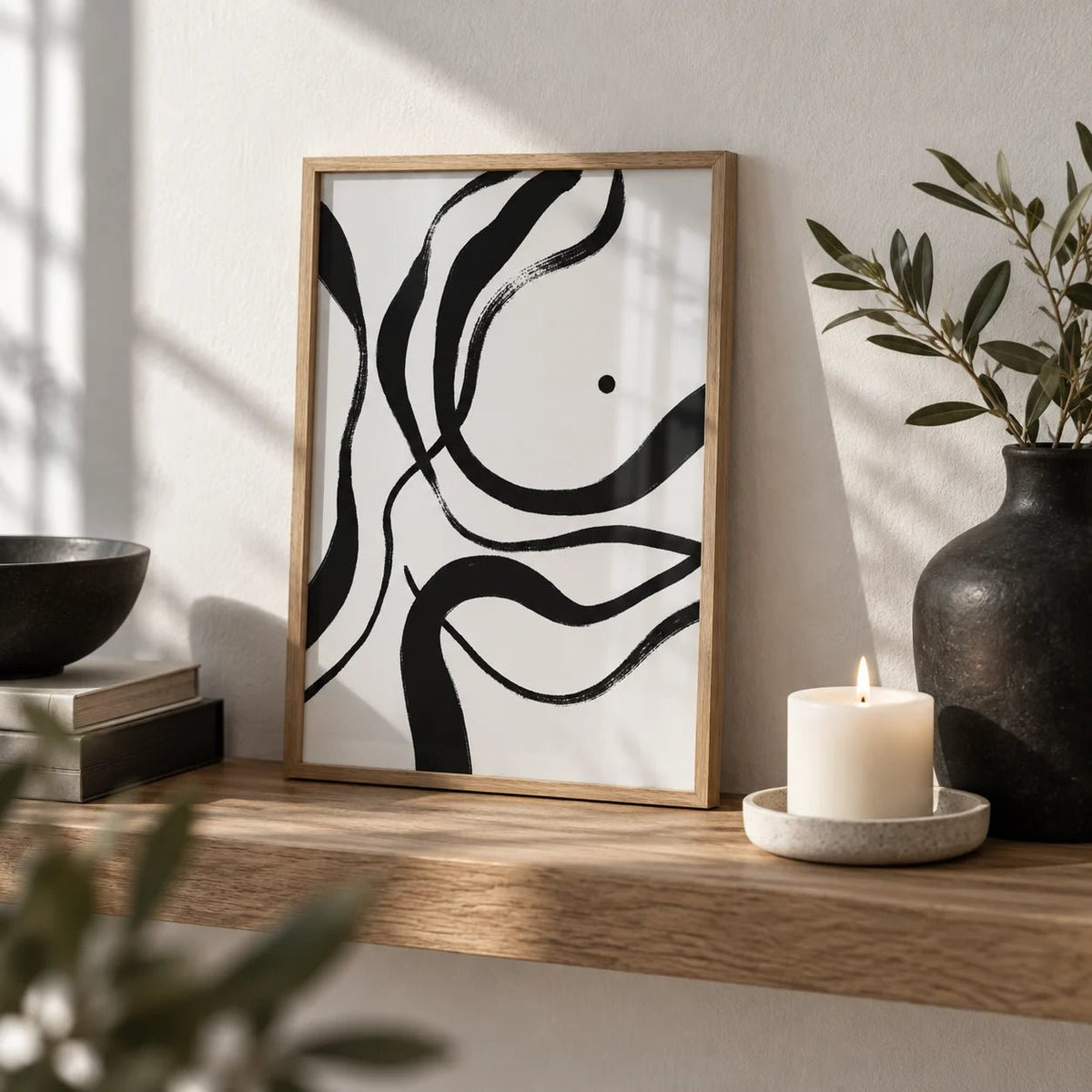 Black And White Art, a small A4 framed print leaning on an oak shelf in a living room