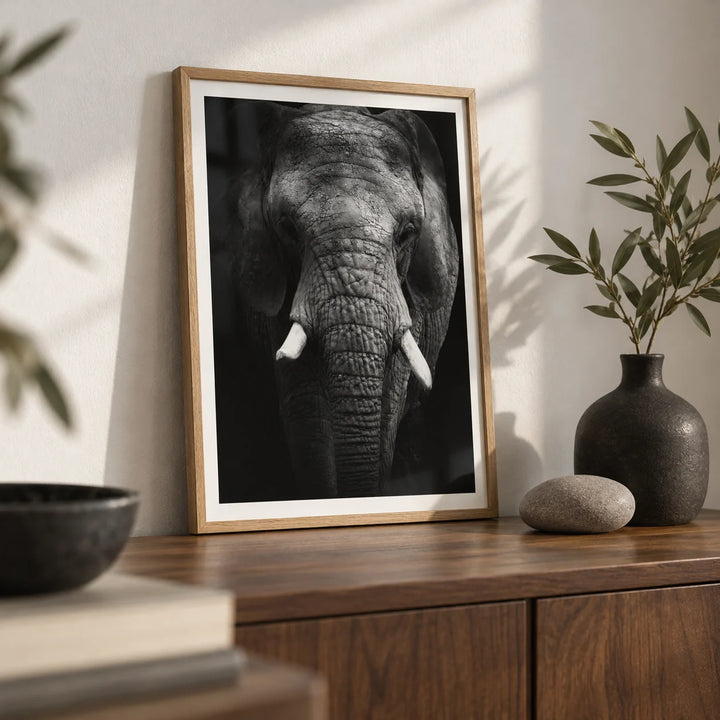 Elephant Print, a small A4 framed print leaning on a walnut side table in a hallway