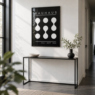 Black and White Geometric Art, framed on the wall of a monochrome hallway with a white wall and a dark grey floor