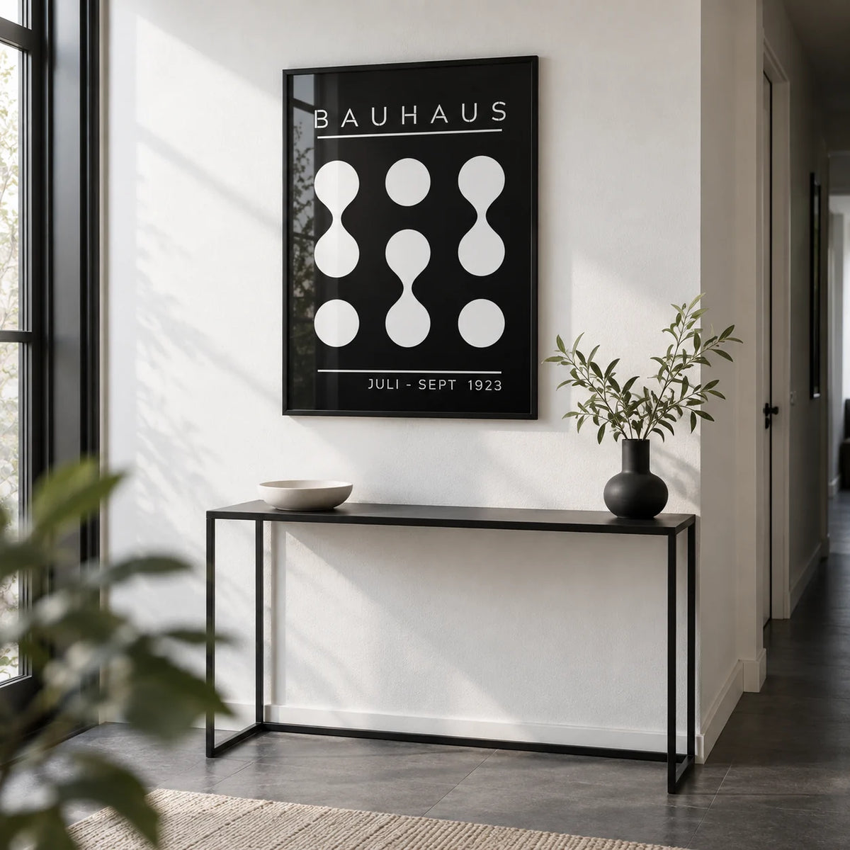 Black and White Geometric Art, framed on the wall of a monochrome hallway with a white wall and a dark grey floor