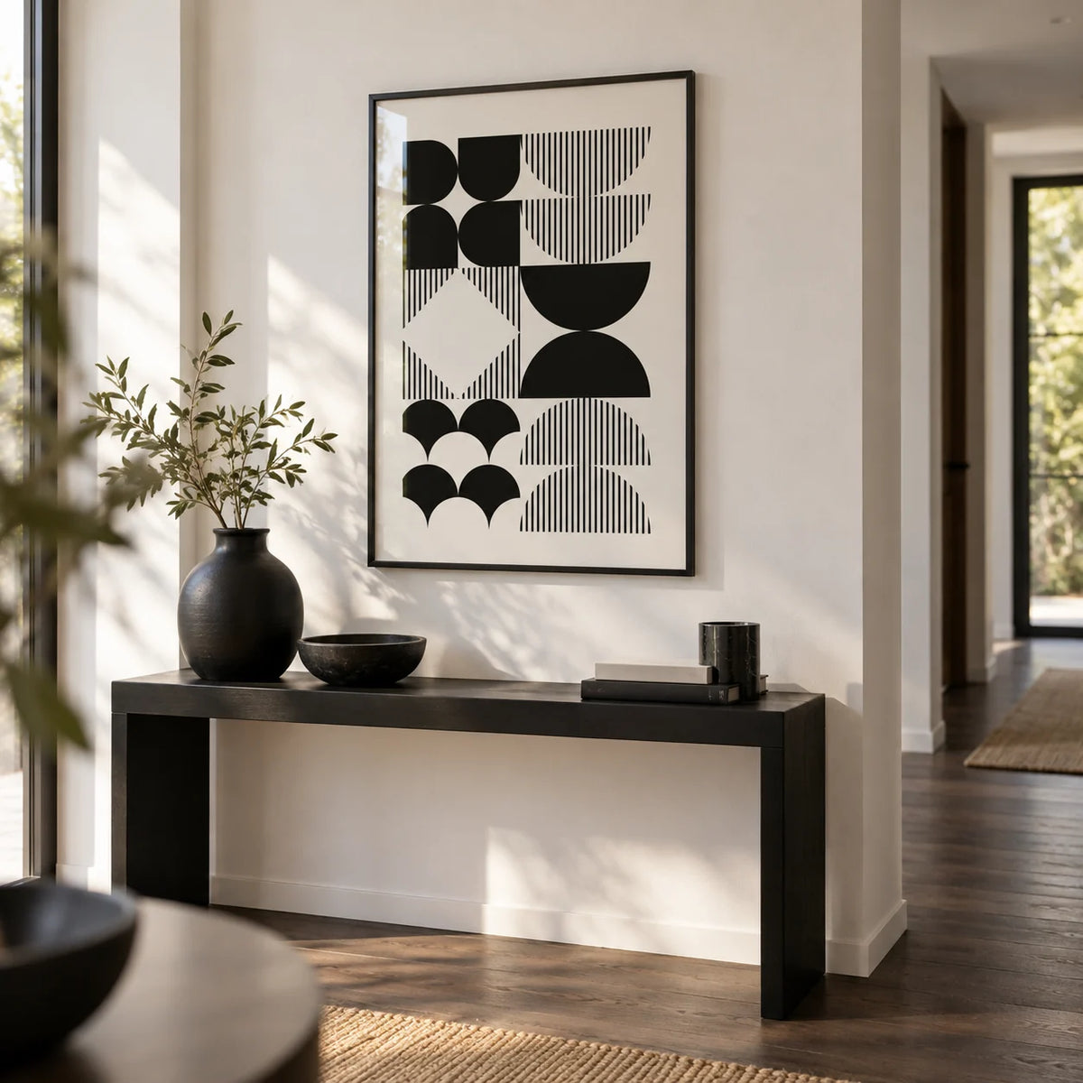 Black and White Geometric Wall Art, framed on the wall of a modern hallway with a white wall and a dark wood floor