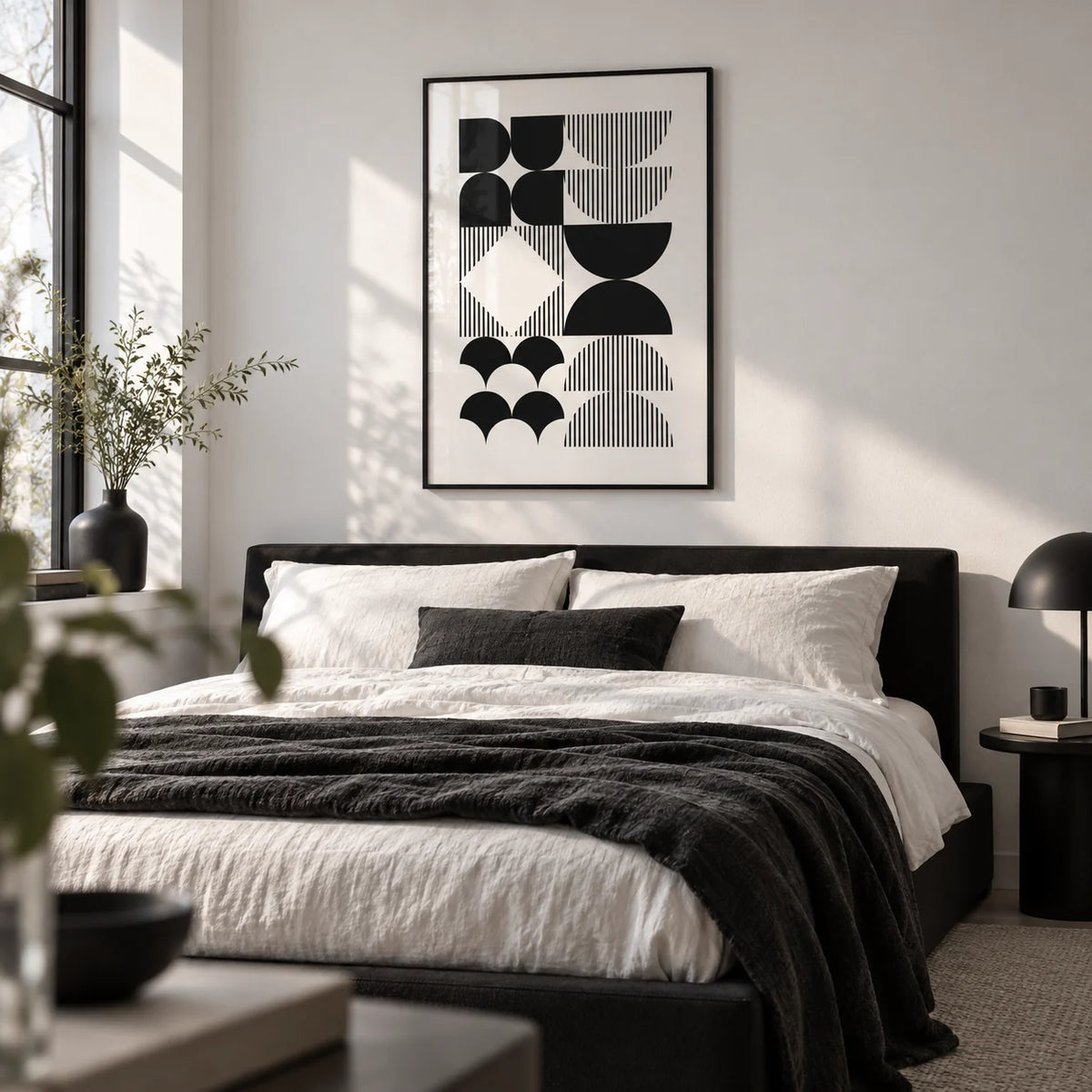 Black and White Geometric Wall Art, framed on the wall of a monochrome bedroom with a white wall