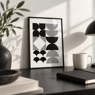 Black and White Geometric Wall Art, a small A4 framed print leaning on a black desk