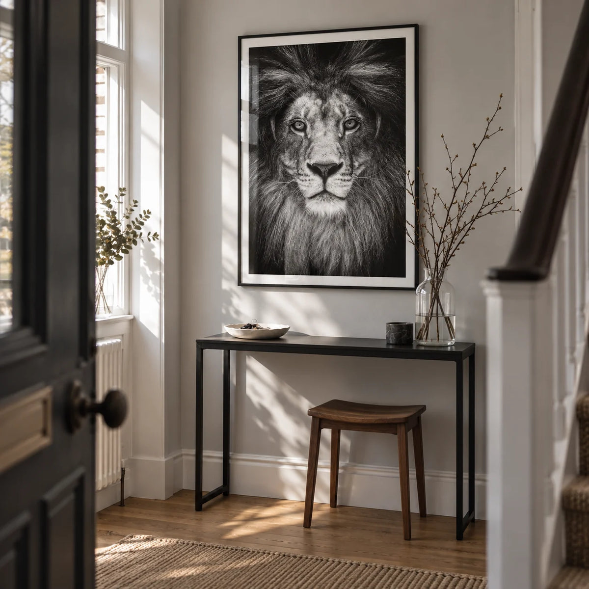 Black And White Lion Print, framed on the wall of a narrow entrance hallway in a renovated UK terrace with a pale grey wall and oak floor