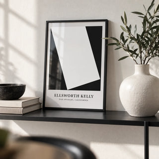 Black and White Office Print, a small A4 framed print leaning on a black metal shelf in a living room