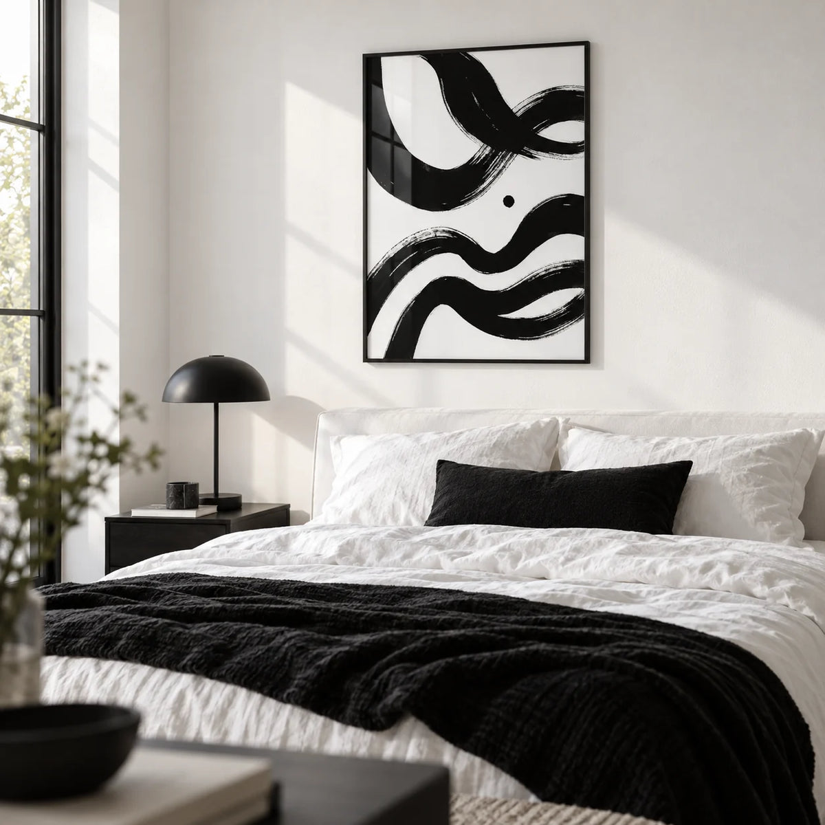 Black And White Paintings Abstract, framed on the wall of a monochrome bedroom with a white wall