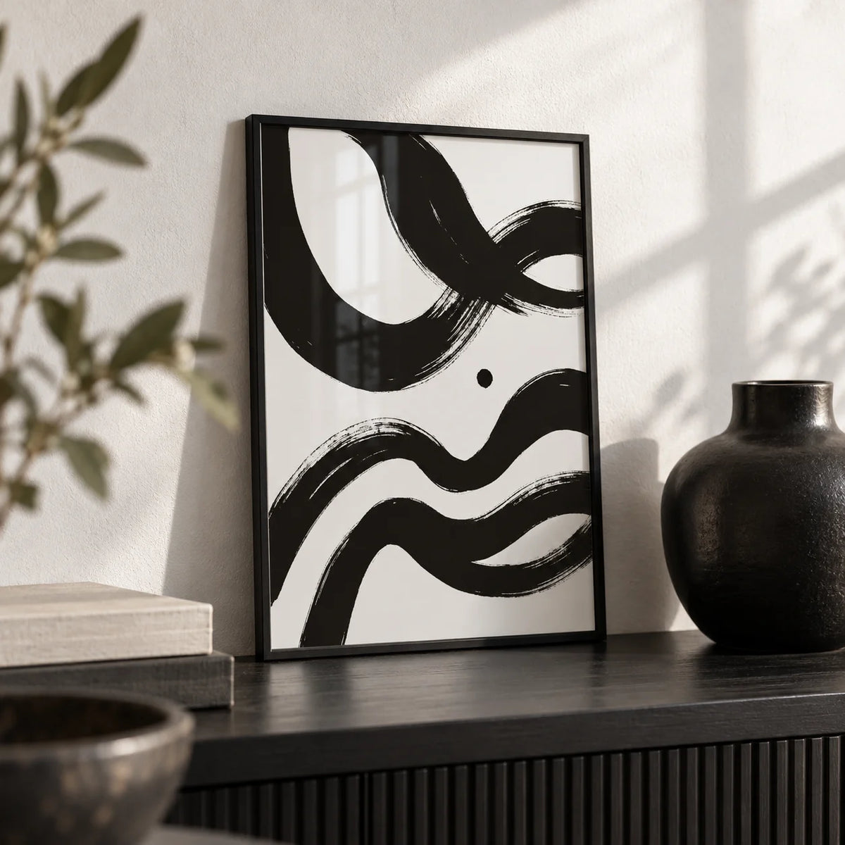 Black And White Paintings Abstract, a small A4 framed print leaning on a black shelf in a living room