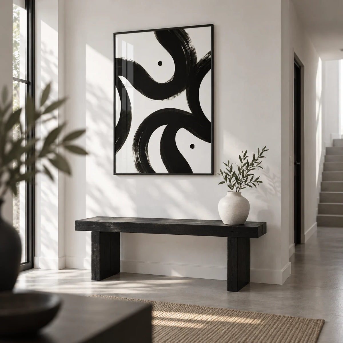 Black and White Posters, framed on the wall of a crisp white hallway with a pale grey floor