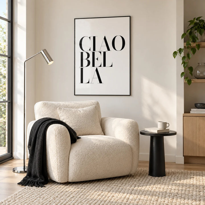 Black and White Typography Poster, framed on the wall of a cosy reading corner with a boucle armchair in a living room