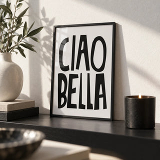 Black and White Typography Poster, a small A4 framed print leaning on a black shelf in a living room
