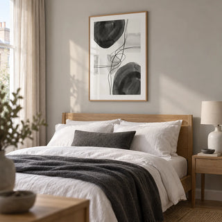 Black And White Wall Art, framed on the wall of a restful modern bedroom in a UK terraced home with a pale grey wall and natural oak furniture