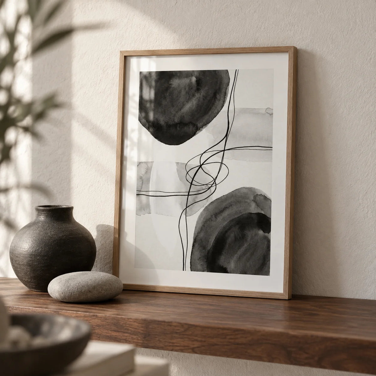 Black And White Wall Art, a small A4 framed print leaning on a walnut shelf in a living room