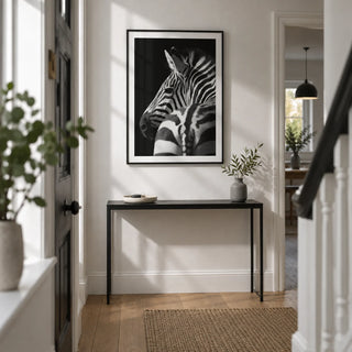 Black And White Zebra Print, framed on the wall of a narrow modern hallway in a renovated UK terrace with a white wall and oak floorboards
