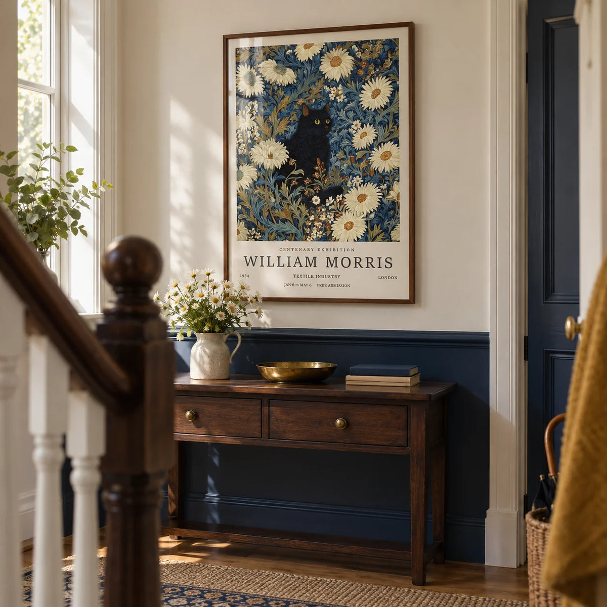Black Cat Art Print, framed on the wall of a terraced house hallway with a navy lower wall and a cream upper wall