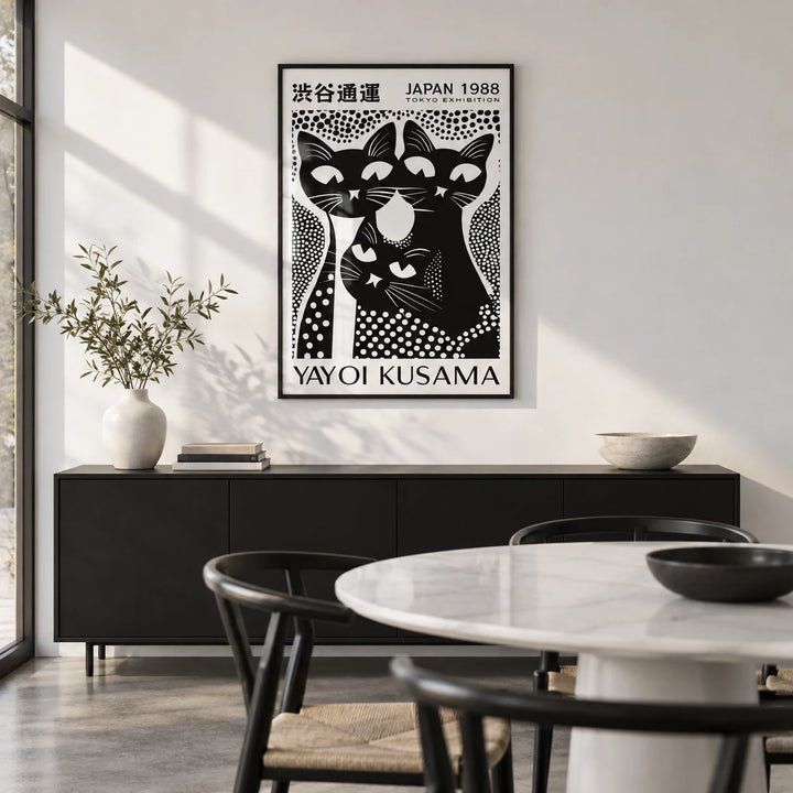 Black Cat Poster Art, framed on the wall of a design-led dining room with a white wall and a polished concrete floor