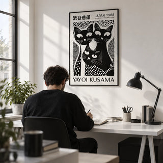Black Cat Poster Art, framed on the wall of a monochrome home office with a white wall