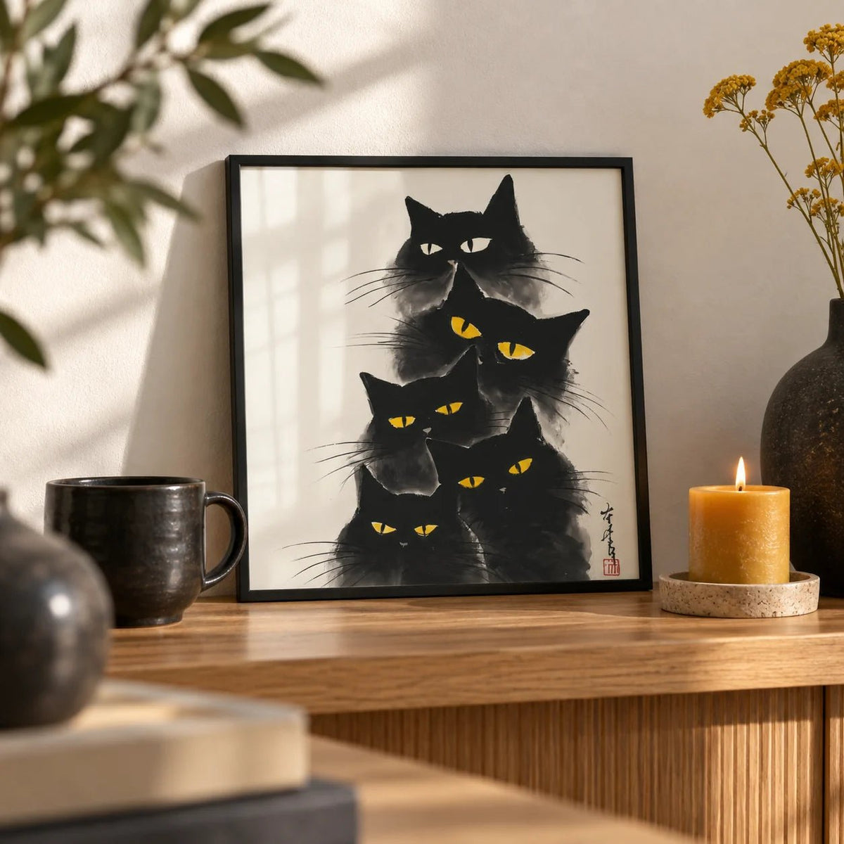 Black Cat Poster, a small A4 framed print leaning on an oak shelf in a living room
