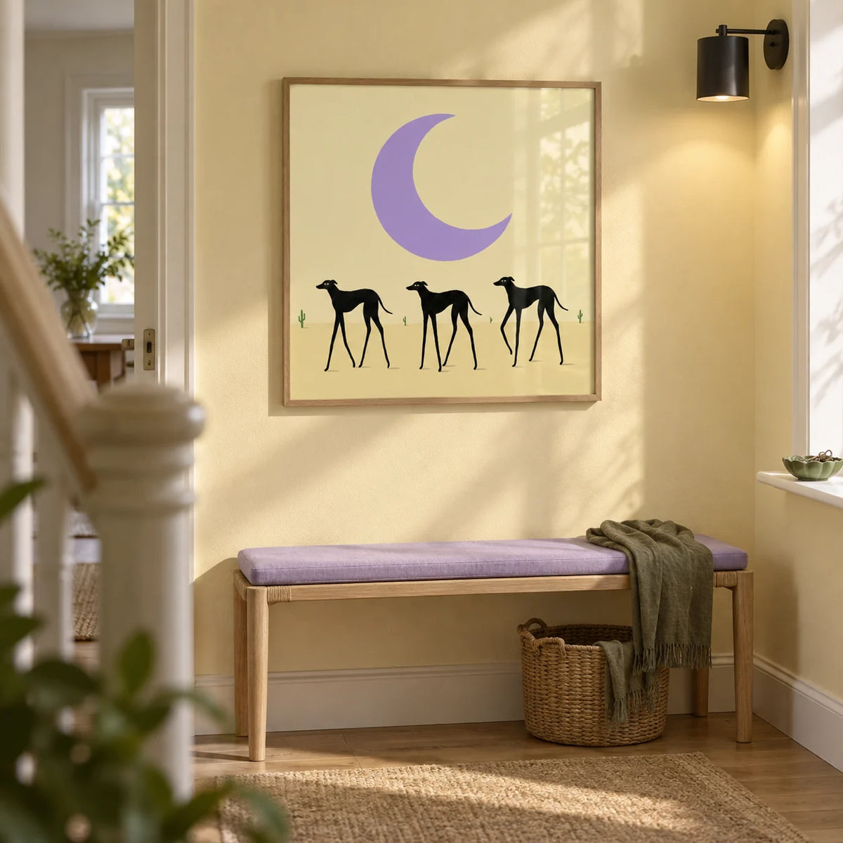 Black Dog Art Print, framed on the wall of a bright hallway in a renovated terraced house with pale warm yellow walls