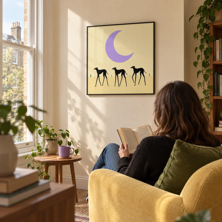 Black Dog Art Print, framed on the wall of a relaxed reading corner beside a tall window in a UK maisonette with warm cream walls in a living room