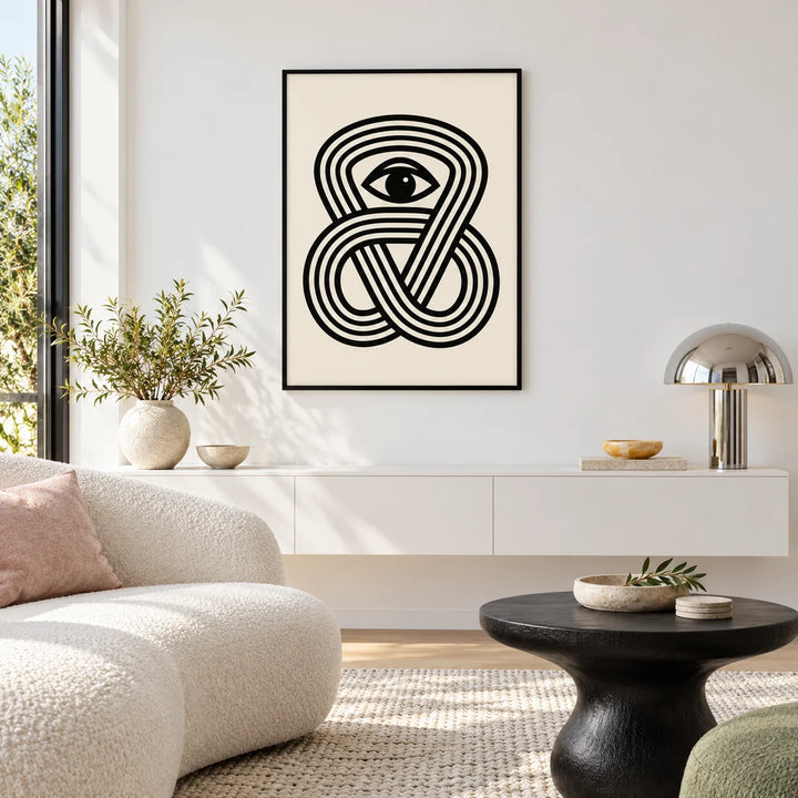 Black Eye Poster, framed on the wall of a sculptural white lounge