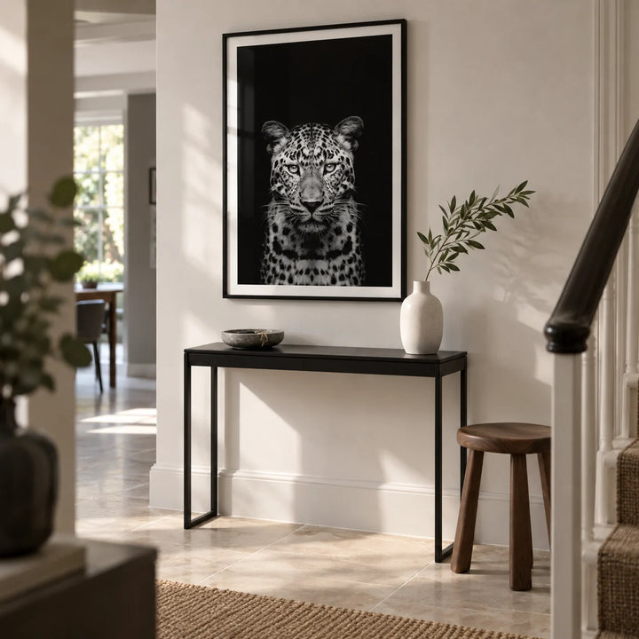 Black Leopard Art Print, framed on the wall of a contemporary hallway in a UK townhouse with a soft white wall and pale stone floor