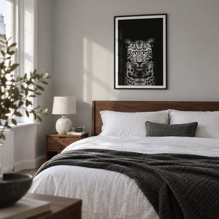Black Leopard Art Print, framed on the wall of a quiet minimalist double bedroom in a renovated UK terraced house with a pale grey wall